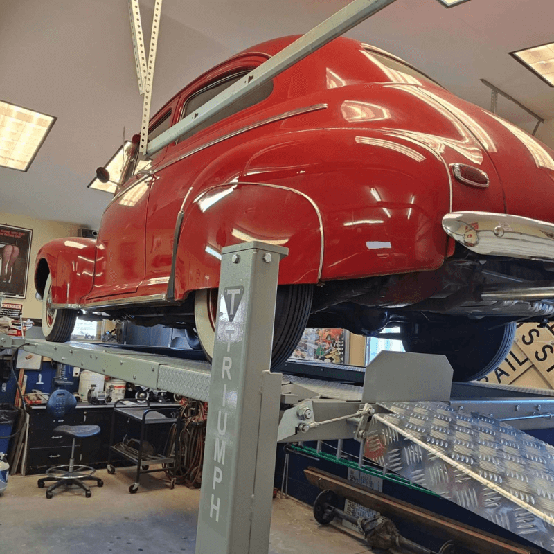 NSS8X-1  4 Post lift with red antique car Michae's Garage Install from Virginia
